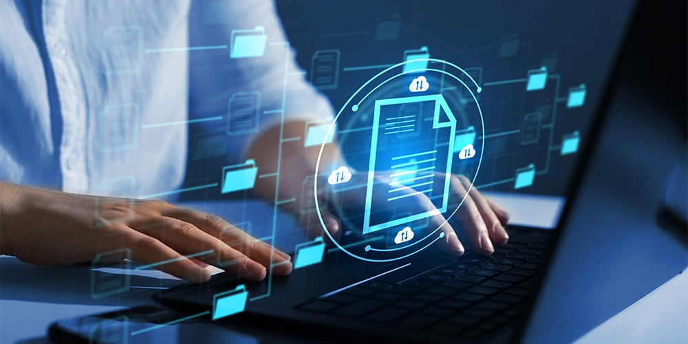 Hands typing on a laptop with a secure document icon and floating digital file and cloud symbols
