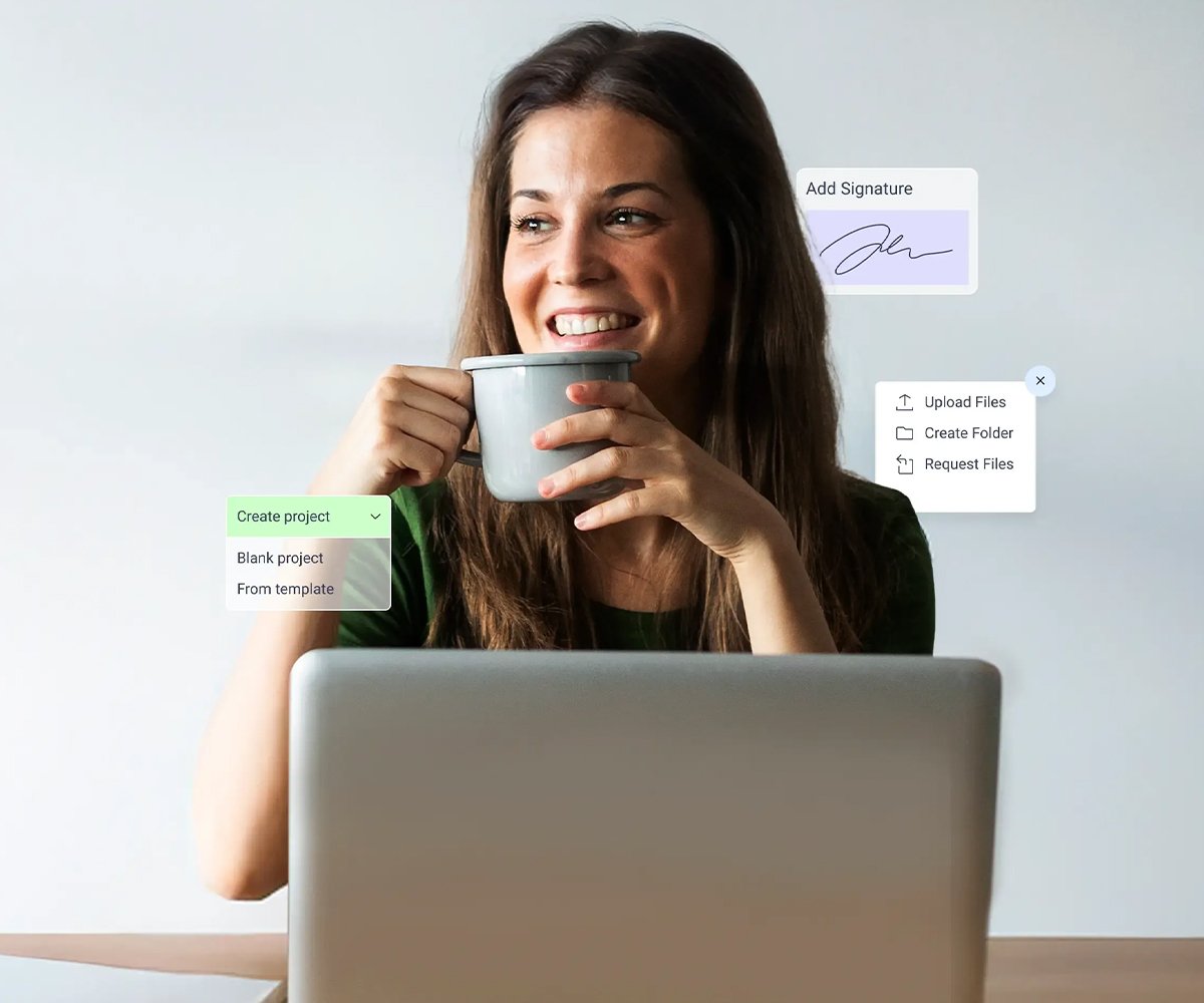 Person sitting at a desk with a laptop, holding a cup, with floating interface elements for file upload and signatures