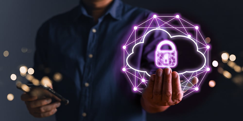 Hand holding a glowing cloud icon with a padlock symbol