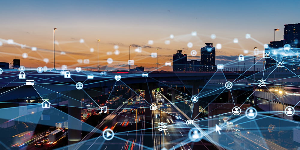 City highway at sunset with digital network icons and connection lines overlaid.