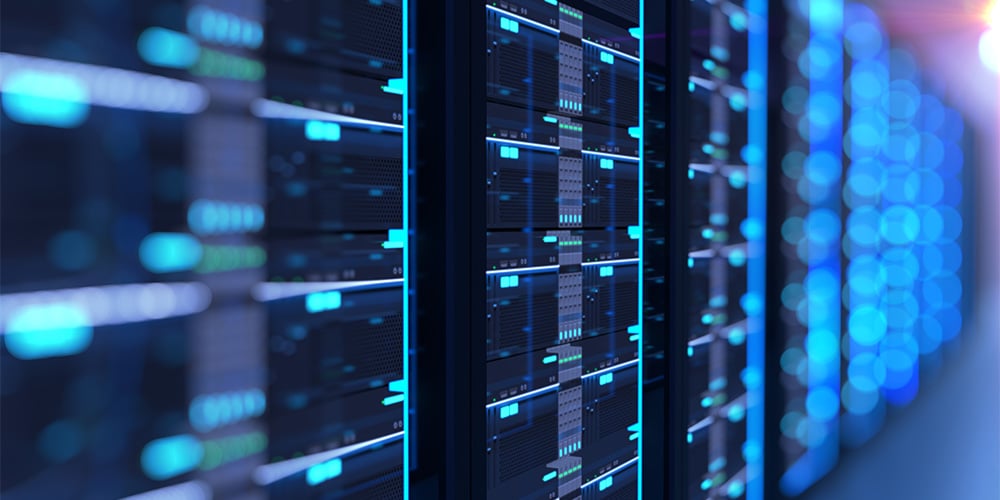 Close-up view of server racks with glowing blue lights in a data center.