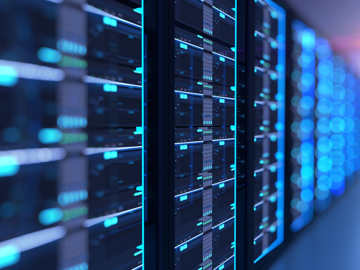 Close-up view of server racks with glowing blue lights in a data center.