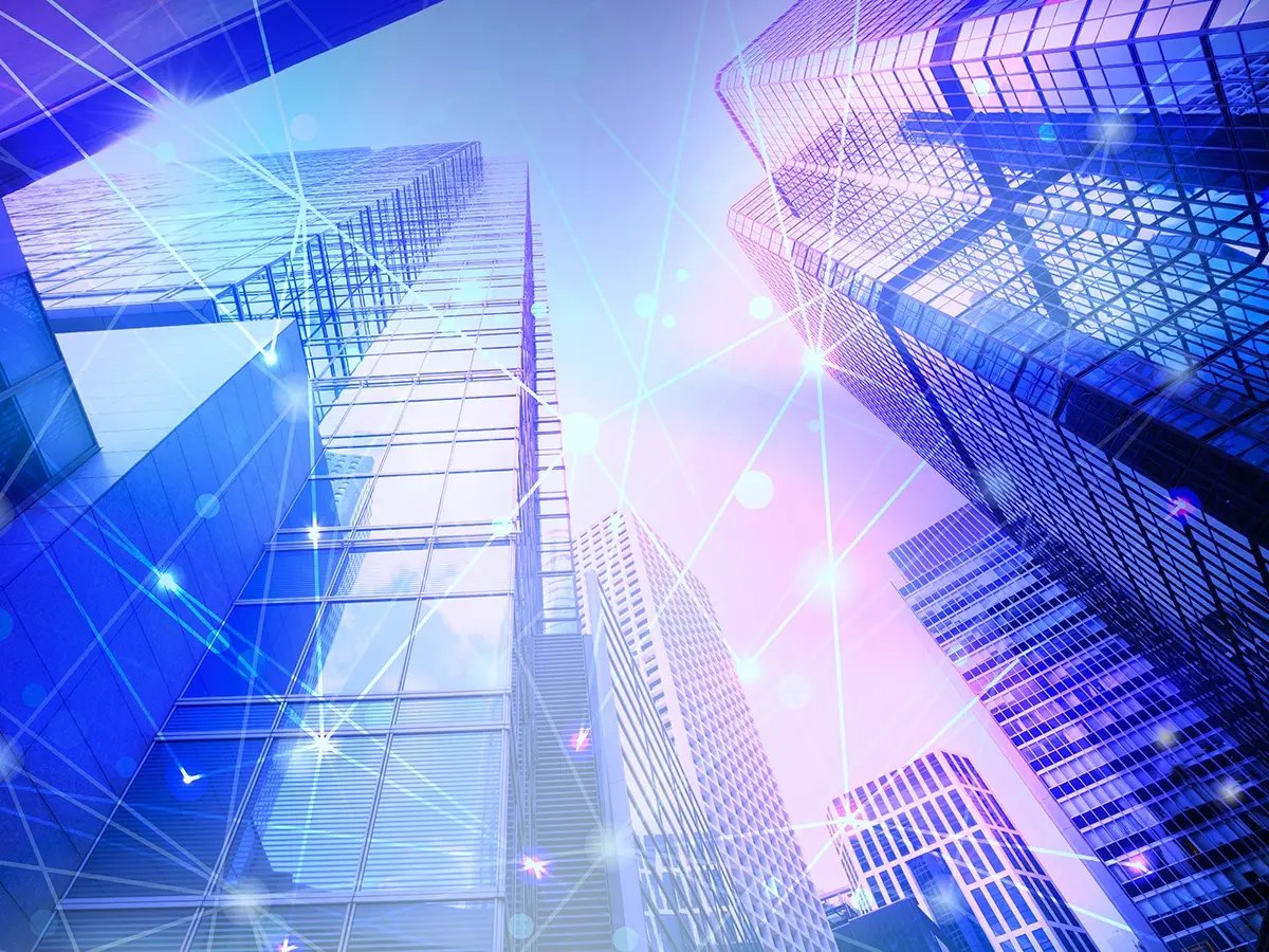 Modern skyscrapers with digital network lines and glowing connection points representing data connectivity.