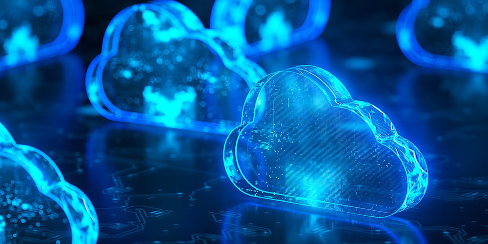 Glowing blue cloud icons on a dark digital surface, symbolising distributed cloud computing.