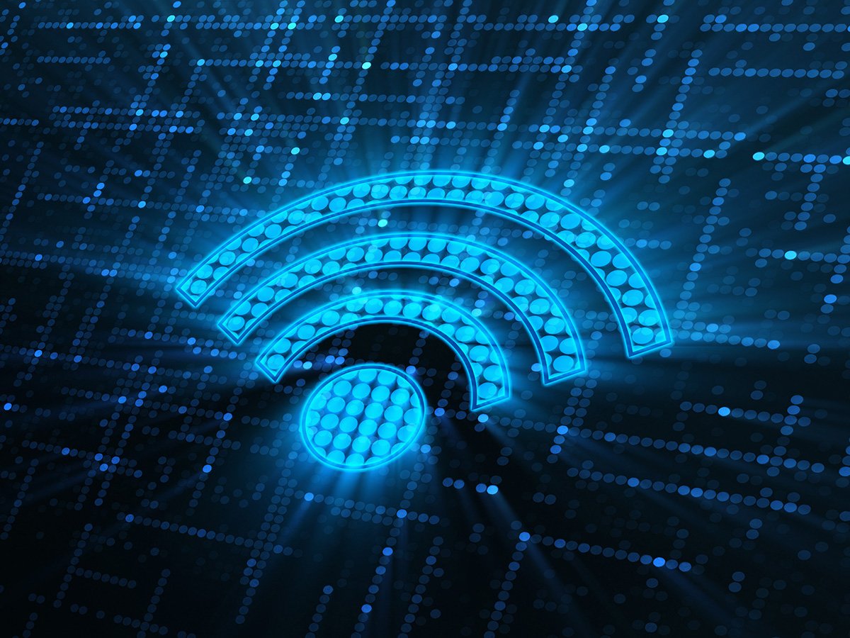 Stylised Wi‑Fi symbol glowing over a digital grid.
