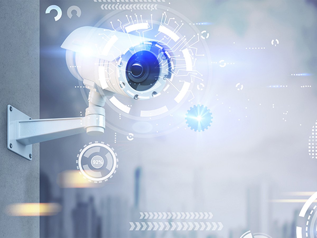 Wall-mounted security camera with digital interface graphics overlay.