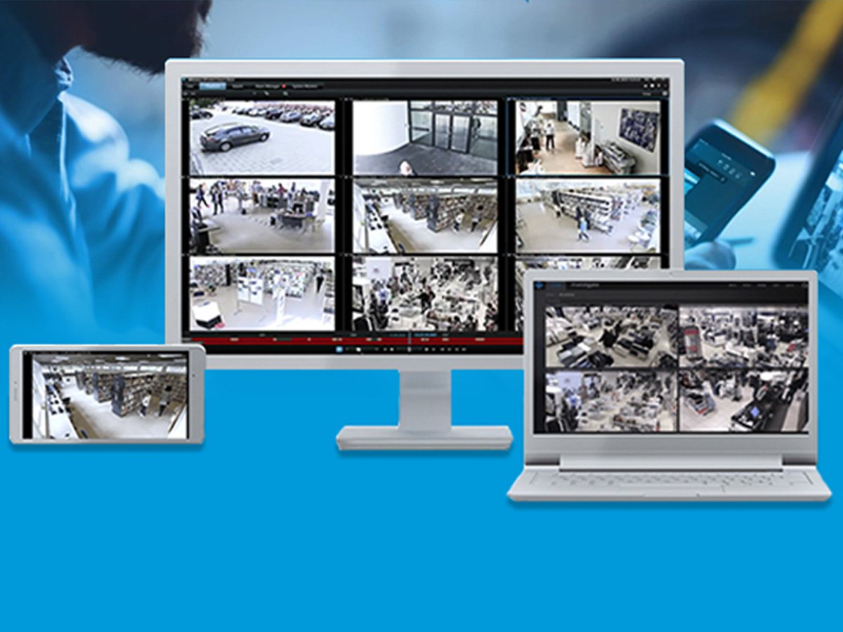 Surveillance camera feeds displayed on a tablet, monitor, and laptop.