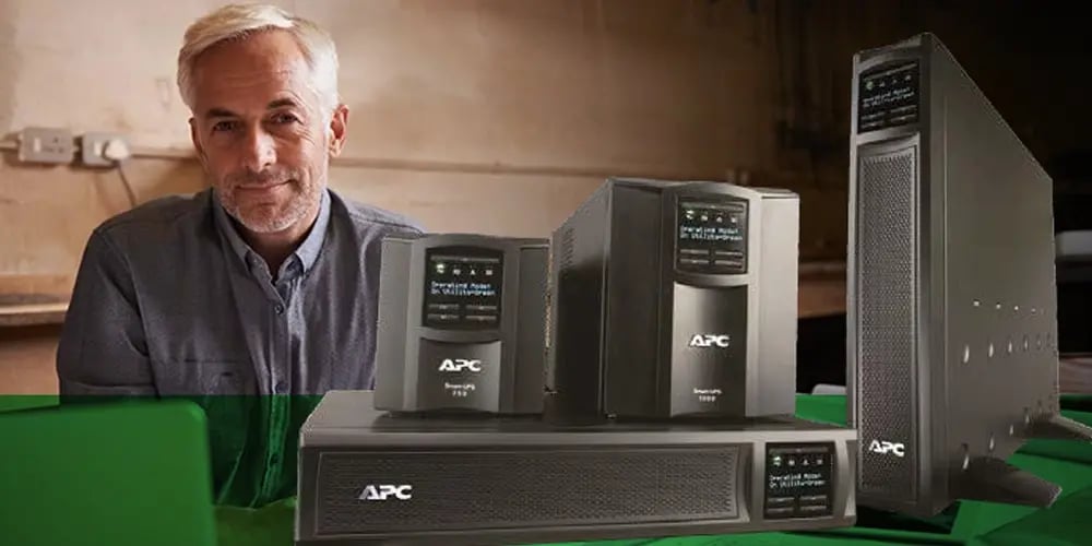 Multiple APC power supply units, including tower and rack-mounted models, displayed on a green surface, representing reliable backup power solutions for IT infrastructure.