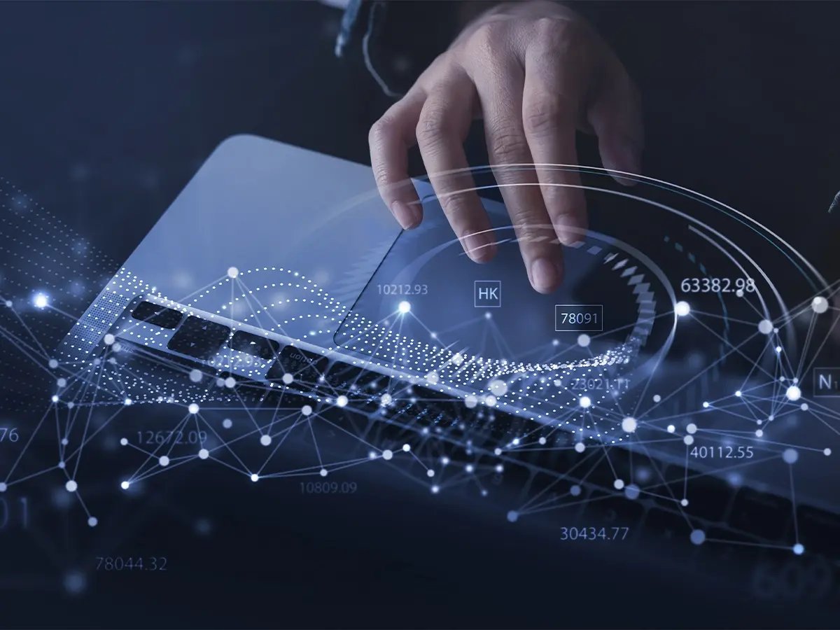 Hands typing on a laptop keyboard overlaid with digital network graphics, numbers, and data points, symbolizing secure data erasure and information protection.