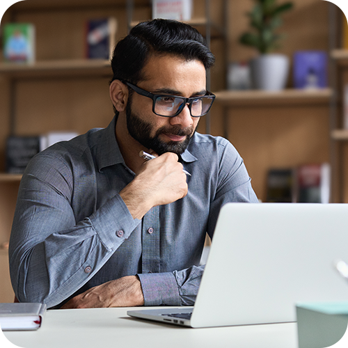 Person sitting at a desk on a laptop